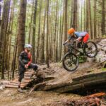 Rider executing a drop on a blue trail in Squamish for our Foundation Blue mountain bike skills clinic