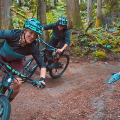 Two riders practicing their cornering skills during a mountain bike cornering clinic in Squamish