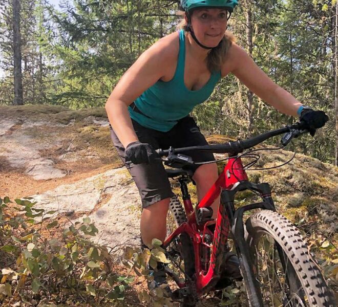 A woman riding her mountain bike on a blue rated trail in Squamish, British Columbia