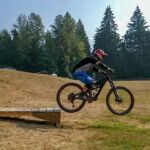 A rider flying off a drop during a RideHub mountain bike drops skills camp