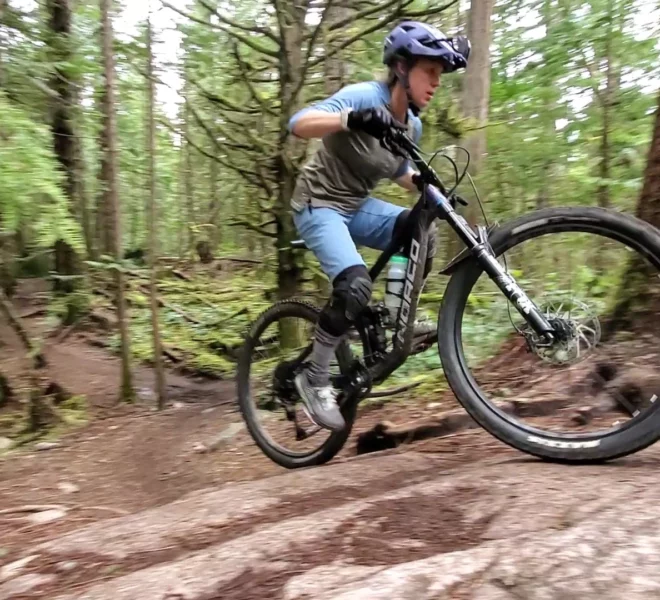 A rider going up a punchy section of trail in Squamish using the skills from our mountain bike climbing lessons