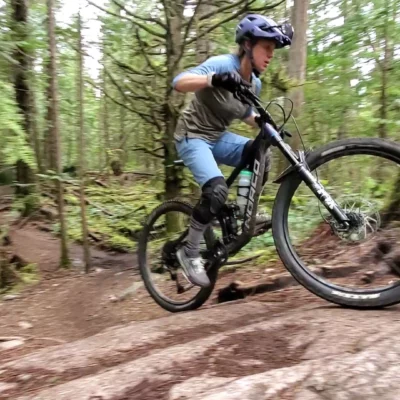 A rider going up a punchy section of trail in Squamish using the skills from our mountain bike climbing lessons