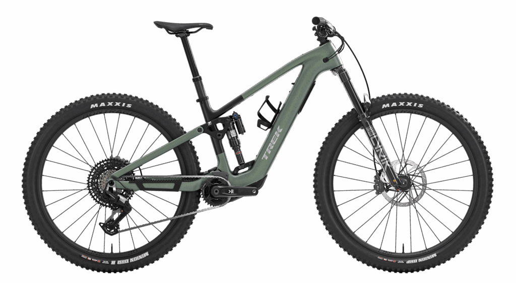 A matte green full-suspension mountain bike with thick Maxxis tires, disc brakes, and a robust frame is shown against a white background.