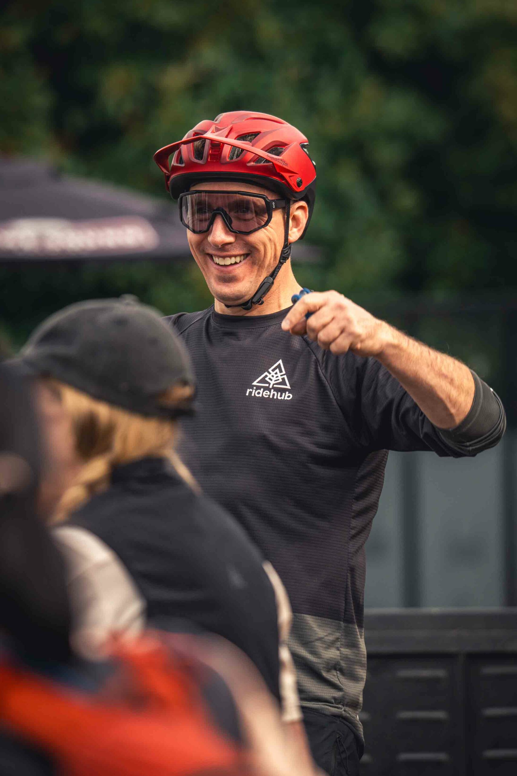 Meet the Team 5 A man wearing a red helmet, sunglasses, and a