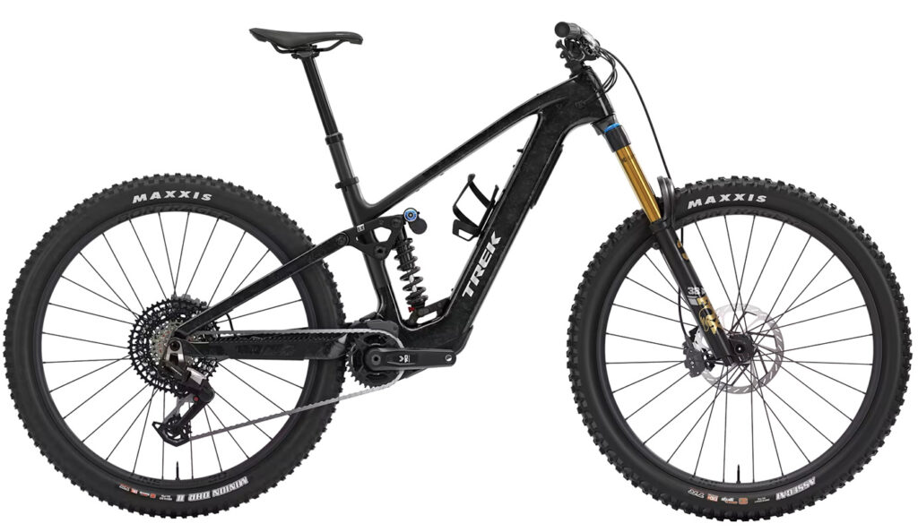 A full-suspension black Trek electric mountain bike with thick tires, dropper seatpost, and visible battery and motor mounted in the frame.