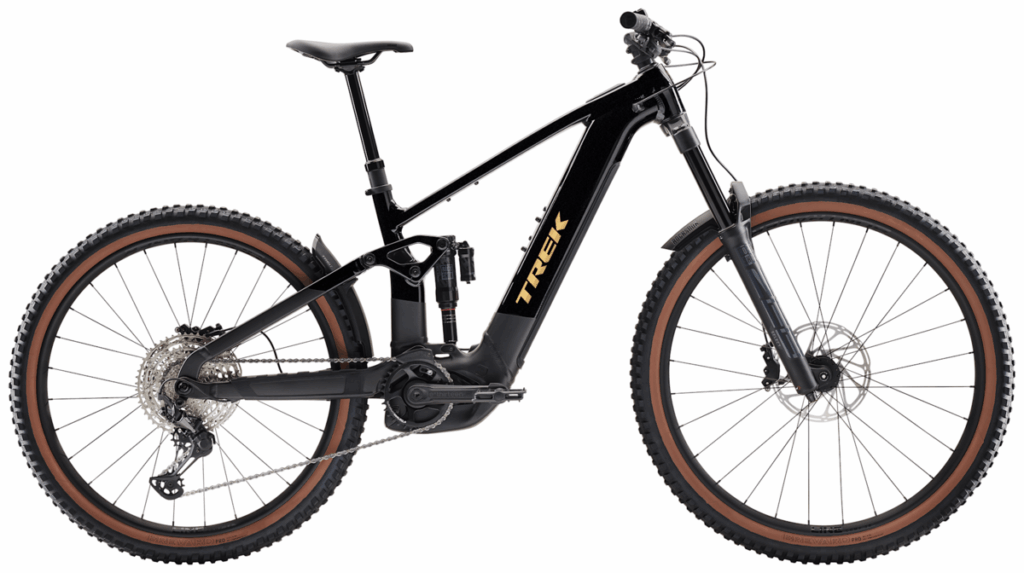 A black Trek electric mountain bike with a front suspension fork, thick knobby tires, and visible battery mounted on the frame.